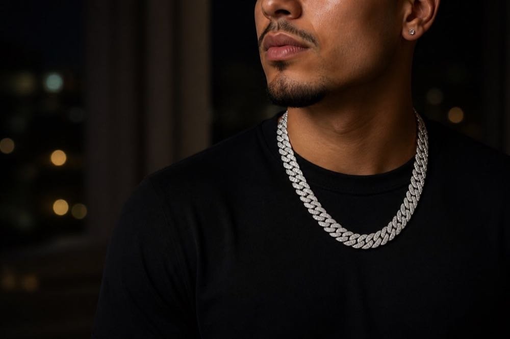 Stone-set Cuban chain worn with a black shirt