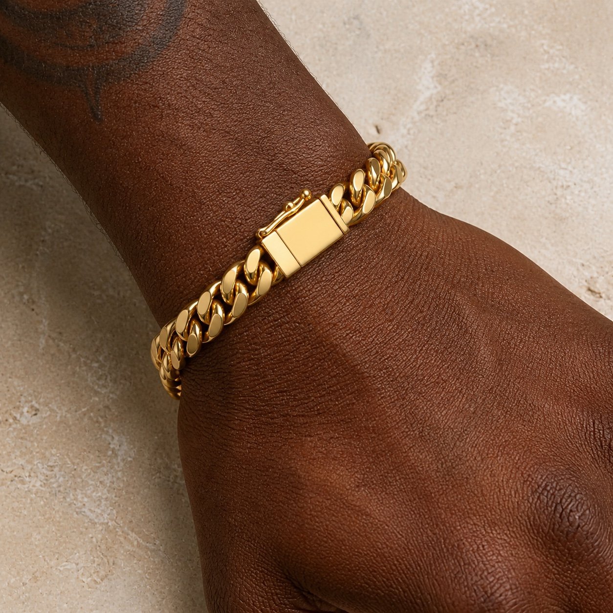 10mm gold finish stainless steel cuban link bracelet 10mm Gold-Finish Stainless Steel Cuban Link Bracelet — close worn view
