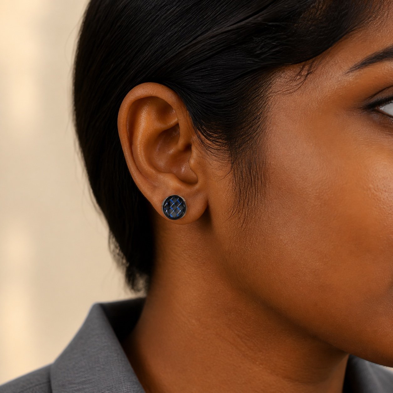 9mm Black-Finish Stainless Steel Blue Carbon-Fiber Stud Earrings — close worn view 9mm Black-Finish Stainless Steel Blue Carbon-Fiber Stud Earrings — close worn view