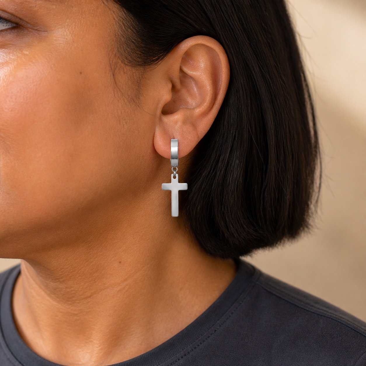 Polished Stainless Steel Cross Earrings — close worn view Polished Stainless Steel Cross Earrings — close worn view