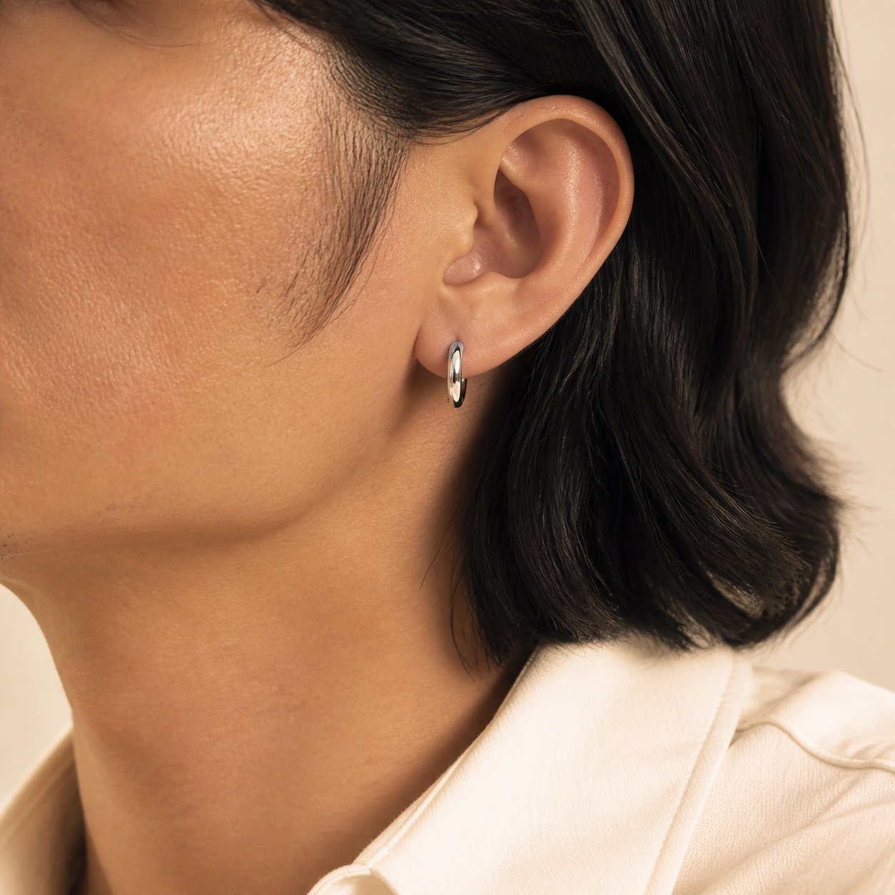 17mm Polished Stainless Steel Hoop Earrings — close worn view 17mm Polished Stainless Steel Hoop Earrings — close worn view