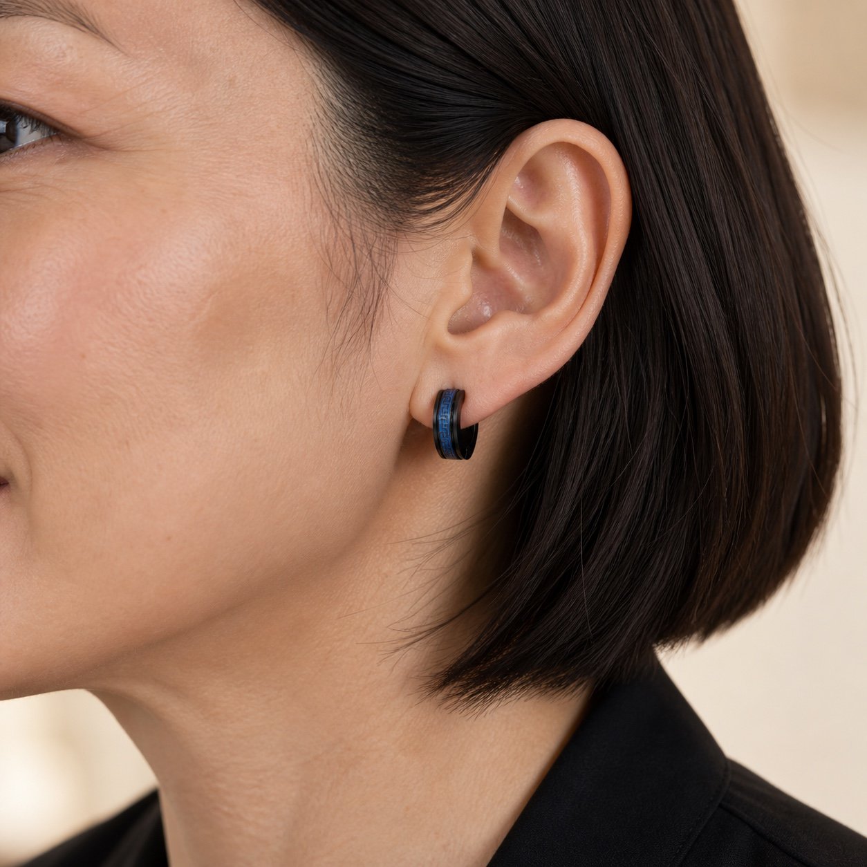 14mm black & blue greek key stainless steel hoop earrings — close worn view 14mm Black & Blue Greek-Key Stainless Steel Hoop Earrings — close worn view