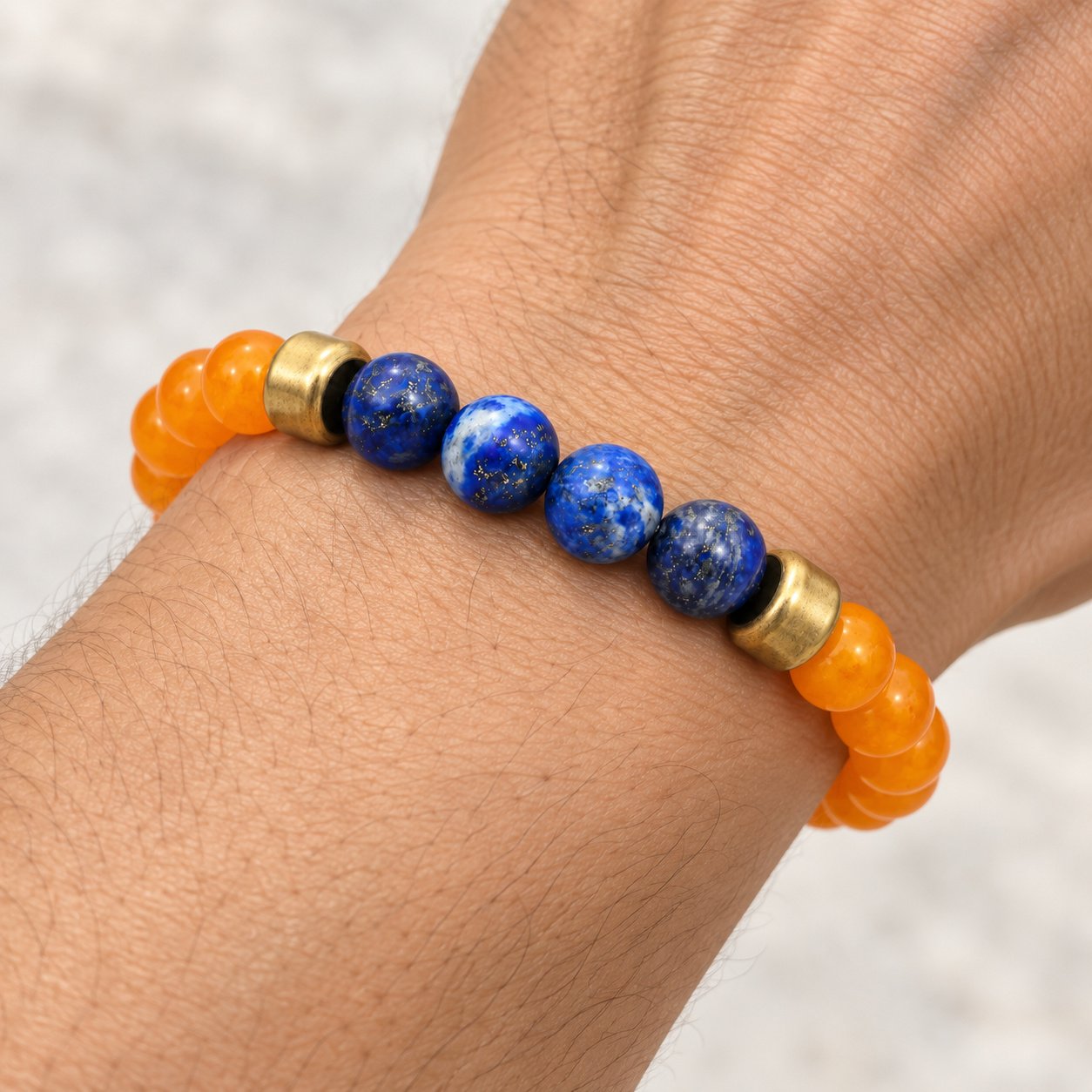 lapis lazuli & orange carnelian gold tone beaded bracelet — close worn view Lapis Lazuli & Orange Carnelian Gold-Tone Beaded Bracelet — close worn view